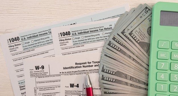 1040-formulario-individual-com-dinheiro-conosco-conceito-de-tempo-de-imposto-contador_359031-11732