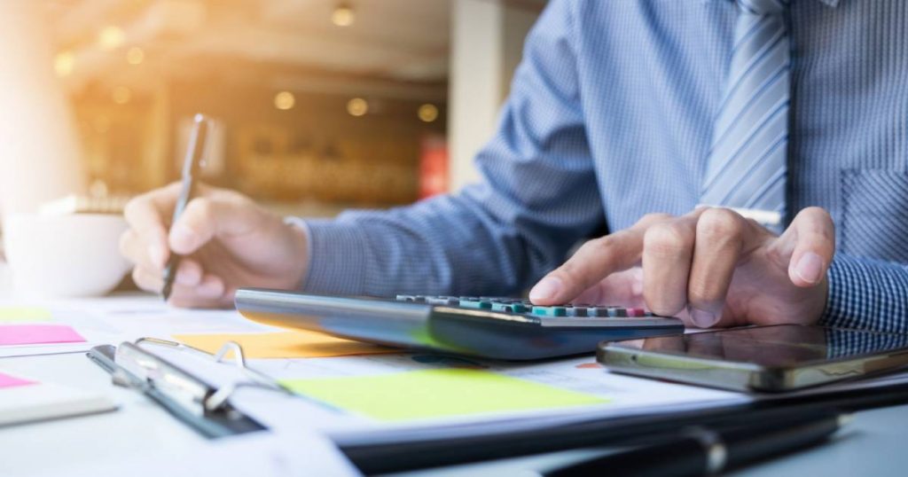 business-finance-man-calculating-budget-numbers-invoices-and-financial-adviser-working(1)