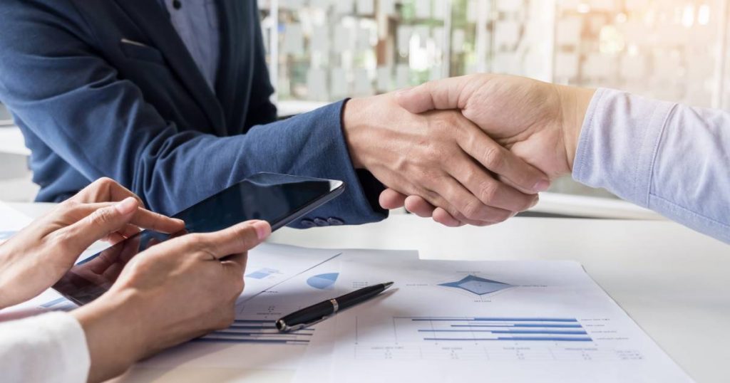 business-handshake-of-two-men-demonstrating-their-agreement-to-sign-agreement-or-contract-between-their-firms-companies-enterprises(1)