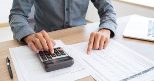 button-bookkeeper-calculating-white-calculator-scaled(1)